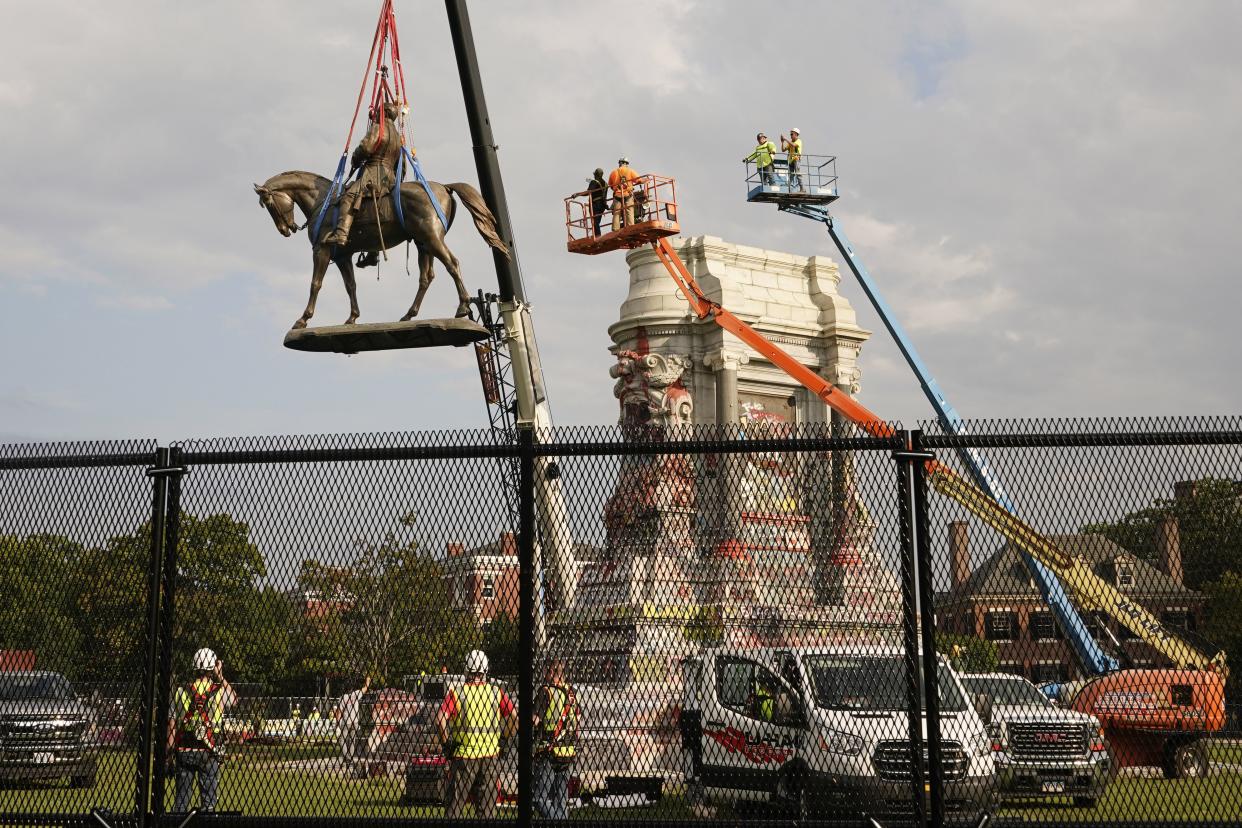 Crews remove a statue of Confederate General Robert E. Lee on Monument Avenue Wednesday, Sept. 8, 2021, in Richmond, Va. The Commonwealth of Virginia is removing the largest Confederate statue remaining in the U.S. following authorization by all three branches of state government, including a unanimous decision by the Supreme Court of Virginia.