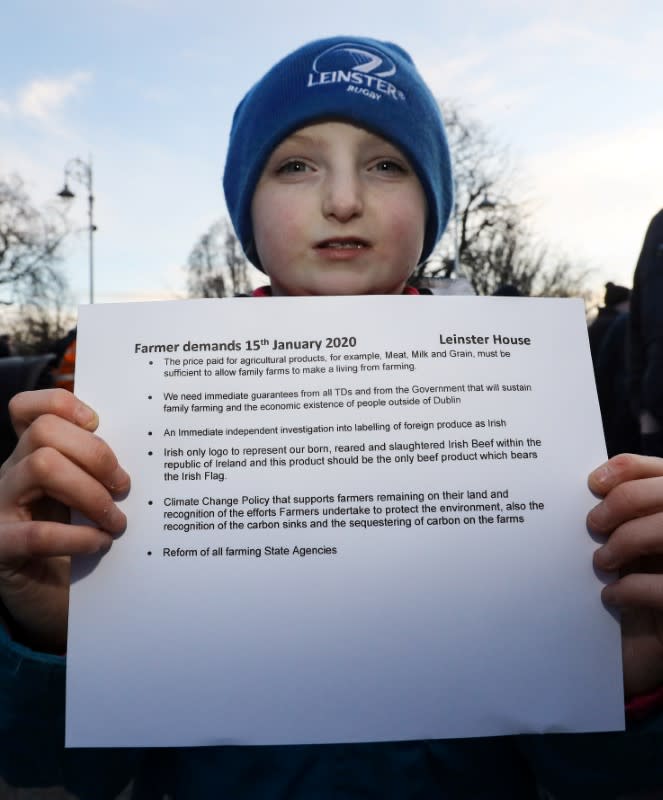 Shauna Smith from Cavan holds a list of the farmers' demands during protest near Government Buildings in Dublin