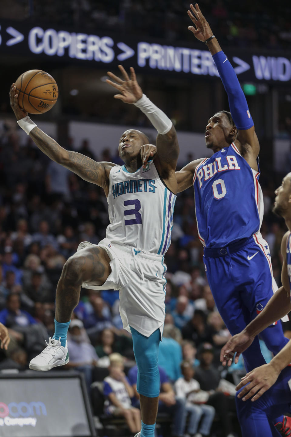 Charlotte Hornets guard Terry Rozier III, left, drives to the basket past Philadelphia 76ers guard Josh Richardson in the second half of a preseason NBA basketball game in Winston-Salem, N.C., Friday, Oct. 11, 2019. (AP Photo/Nell Redmond)