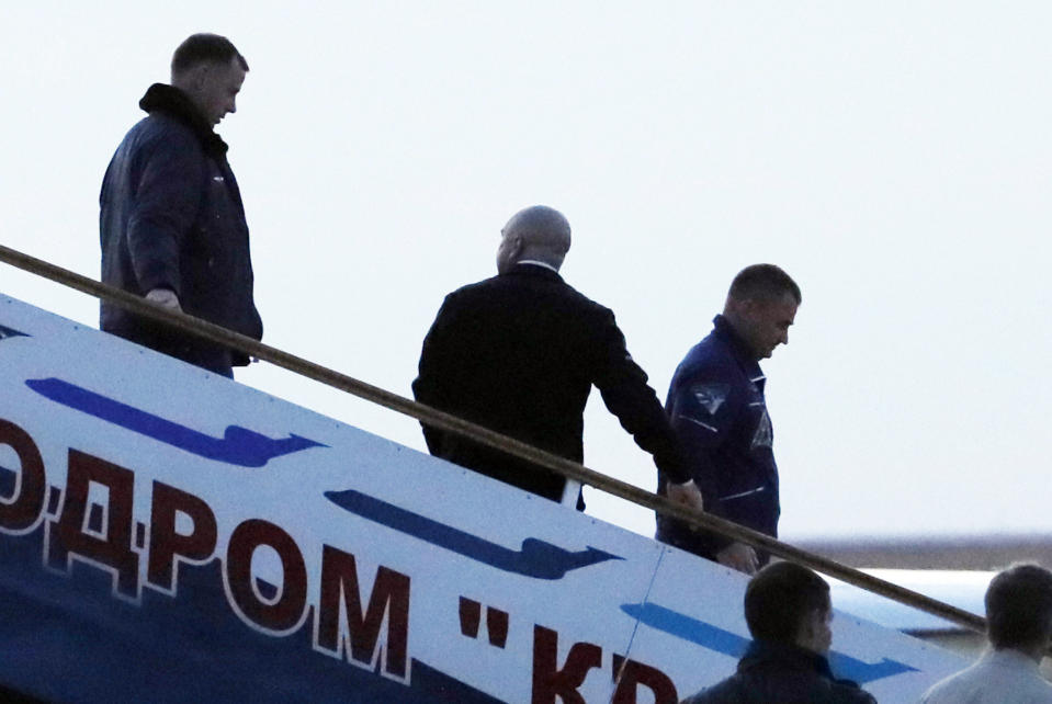 U.S. astronaut Nick Hague, left, and Russian cosmonaut Alexey Ovchinin, right, arrive in Baikonur airport, Kazakhstan, Thursday, Oct. 11, 2018, after an emergency landing following the failure of a Russian booster rocket carrying them to the International Space Station. (Yuri Kochetkov/Pool Photo via AP)