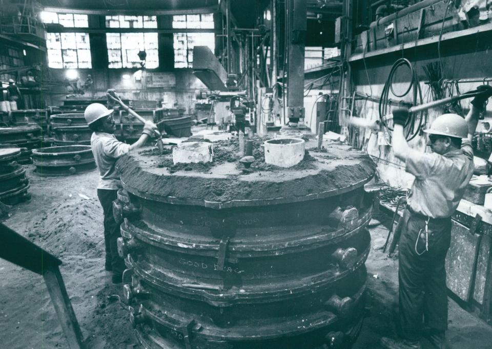 Atlantic Foundry Co. workers level off sand in a mold at the Akron complex in 1980.