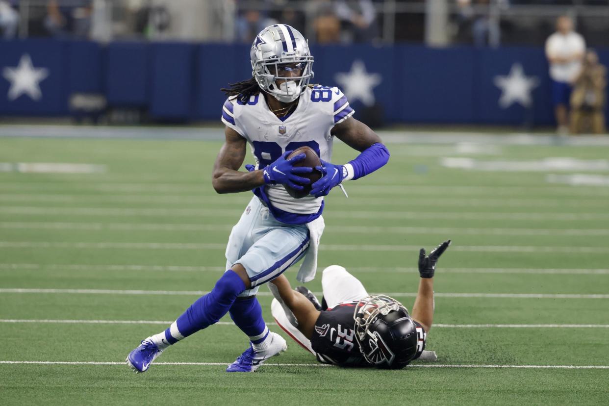 Dallas Cowboys wide receiver CeeDee Lamb (88) gains yards after catching a pass as Atlanta Falcons cornerback Avery Williams (35) defends in the first half of an NFL football game in Arlington, Texas, Sunday, Nov. 14, 2021. (AP Photo/Ron Jenkins)