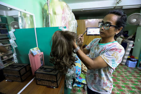 Makeup artist Lynn Lynn cleans her wig collection in her studio in Yangon, Myanmar September 24, 2018. REUTERS/Ann Wang