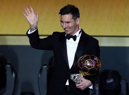 FC Barcelona's Lionel Messi of Argentina holds the World Player of the Year award during the FIFA Ballon d'Or 2015 ceremony in Zurich, Switzerland, January 11, 2016. REUTERS/Arnd Wiegmann/File Photo