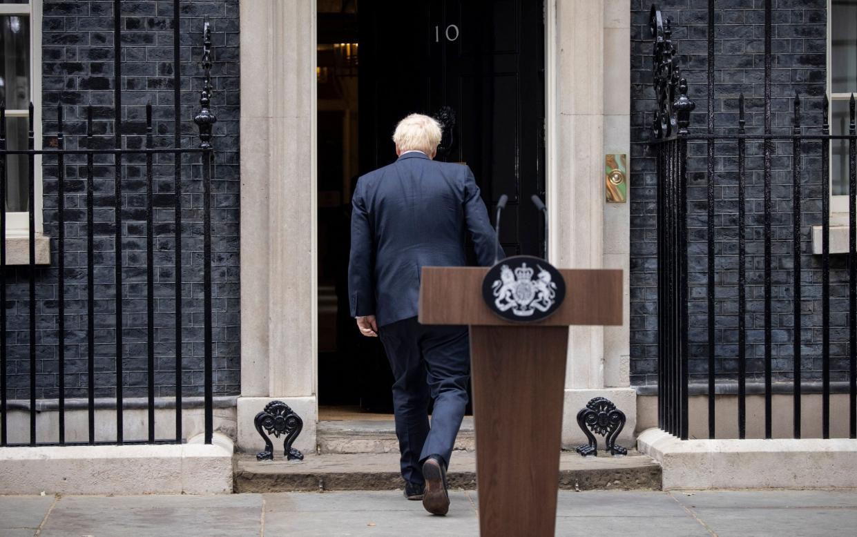 Boris Johnson turns and heads back inside Number 10 after announcing his resignation - Tolga Akmen/Shutterstock