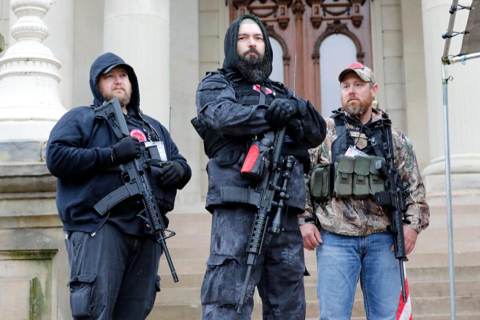 On April 30, 2020, armed men wearing ‘Michigan Liberty Militia’ insignias stood on the steps of the state Capitol building as part of a protest against Gov. Gretchen Whitmer’s lockdown orders. <a href="https://www.gettyimages.com/detail/news-photo/armed-protesters-provide-security-as-demonstrators-take-news-photo/1211395465" rel="nofollow noopener" target="_blank" data-ylk="slk:Jeff Kowalsky/AFP via Getty Images;elm:context_link;itc:0;sec:content-canvas" class="link ">Jeff Kowalsky/AFP via Getty Images</a>