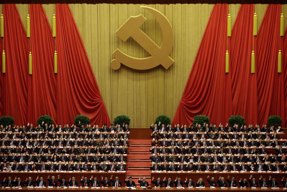 China's top leaders raise their hands to approve work reports during the closing ceremony for the 18th Communist Party Congress at the Great Hall of the People in Beijing Wednesday Nov. 14, 2012. (AP Photo/Ng Han Guan)