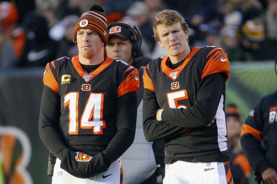 Three weeks after benching veteran Andy Dalton, left, for rookie Ryan Finley, Cincinnati Bengals coach Zac Taylor said Monday he's going back to Dalton. (AP/Frank Victores)