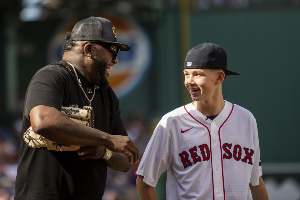 August 26, 2023, Boston, MA:
Former Boston Red Sox player catches the ball as Dominic Driscoll throws out the Ceremonial First Pitch during the Pre Game Ceremony before a game between the Boston Red Sox and the Los Angeles Dodgers at Fenway Park in Boston, Massachusetts Saturday, August 26, 2023.  
(Photo by Armond Feffer/Boston Red Sox)