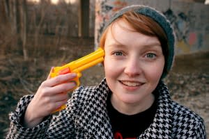 Woman with plastic gun to her head