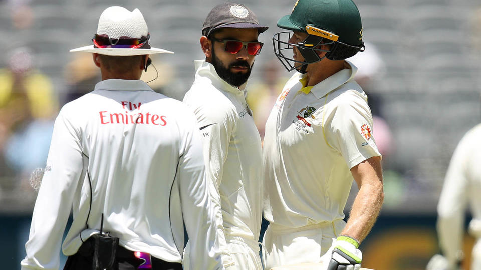 Virat Kohli and Tim Paine bump into each other. (Photo by Cameron Spencer/Getty Images)