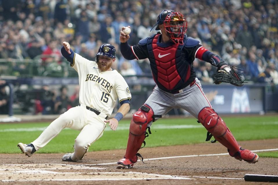 Milwaukee Brewers' Oliver Dunn is forced out at home by Minnesota Twins catcher Christian Vazquez on a ball hit by Sal Frelick during the second inning of a baseball game Tuesday, April 2, 2024, in Milwaukee. (AP Photo/Morry Gash)