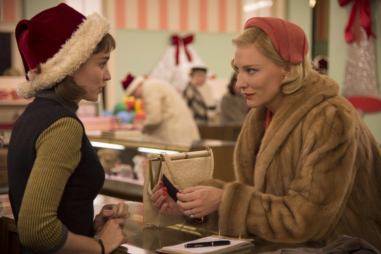 Two women talk at a department store counter in the 1950s