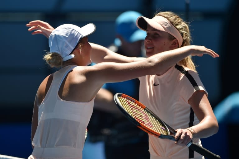 Ukraine's Marta Kostyuk (L) congratulates compatriot Elina Svitolina after their Australian Open third round match, in Melbourne, on January 19, 2018