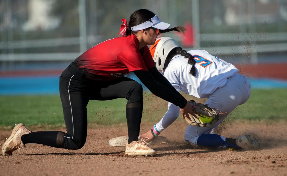 Kimball's Kaeliana DePerio, right, makes it to second safely before the tag by Lincoln's Alicia Ott during a girls varsity softball game at Kimball High in Tracy on Mar. 7, 2024. Kimball won 13-7.