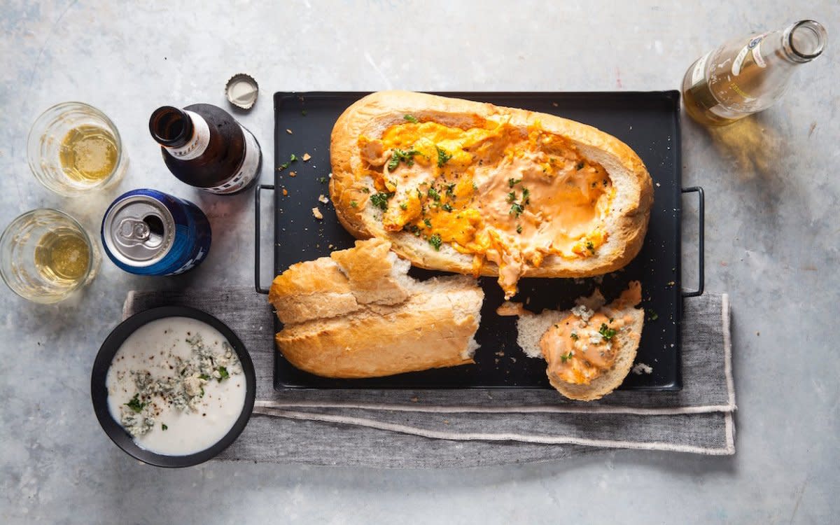 <p>Blue Line Creative</p><p>Think of this as Buffalo chicken dip, in pull-apart bread form. With every tear of bread, you can scoop up the cheesy chicken dip. Sounds heavenly, doesn't it?</p><p><strong>Get the recipe: <a href="/1060169/parade/buffalo-chicken-in-a-bread-boat-recipe/" data-ylk="slk:Buffalo Chicken Bread Boat;elm:context_link;itc:0;sec:content-canvas" class="link rapid-noclick-resp">Buffalo Chicken Bread Boat</a></strong></p>
