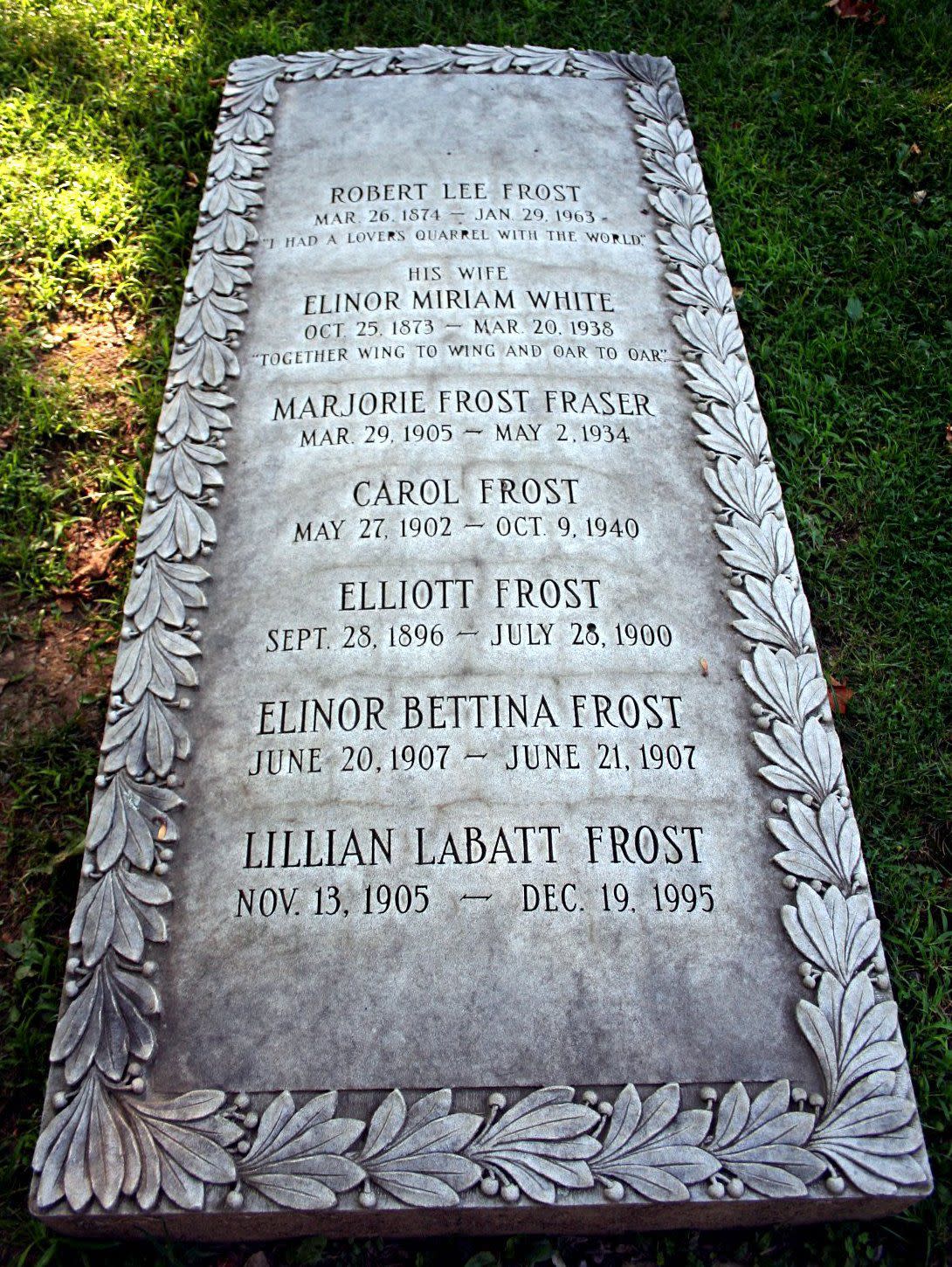 Robert Frost's family grave headstone in the Old Bennington Cemetery, Bennington, Vermont with a list of seven members of the frost family surrounded by grass and light coming in on the right