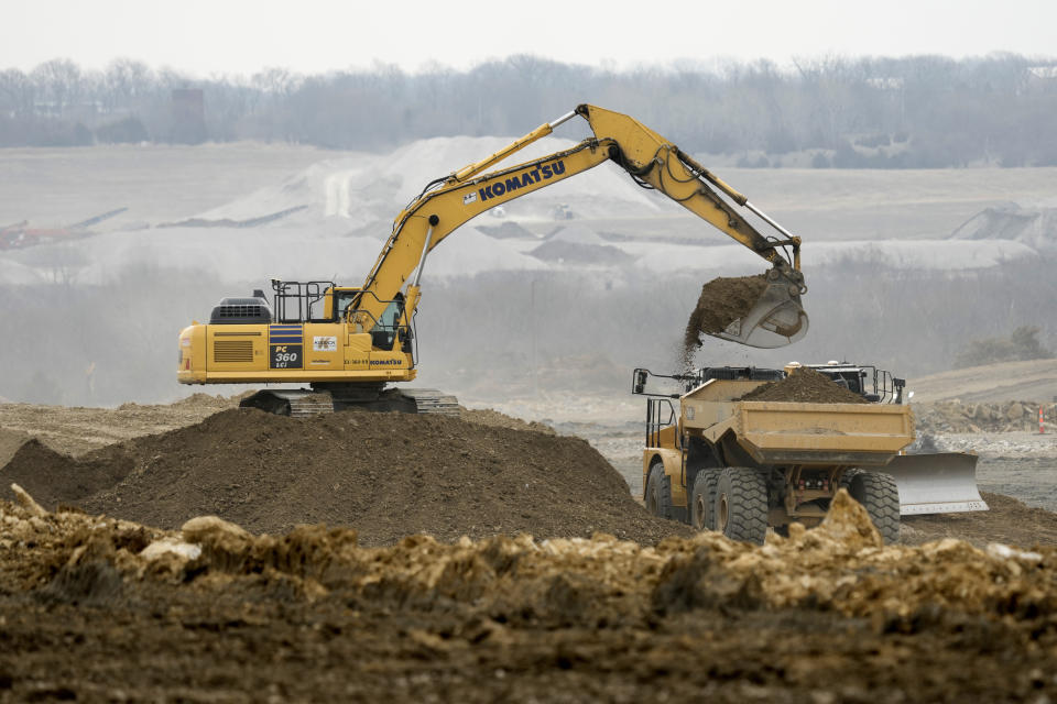 Workers prepare the site of a $4 billion Panasonic EV battery plant Thursday, March 30, 2023, near DeSoto, Kan. Economic incentives offered by Kansas state and local governments beat out those offered by neighboring Oklahoma to help lure the project to the site on land formerly occupied by an Army ammunition plant. (AP Photo/Charlie Riedel)