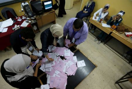 Representatives of the candidates (R), following the officials as they count ballots after polls close at a polling station for parliamentary elections in Amman, Jordan, September 20, 2016. REUTERS/Muhammad Hamed