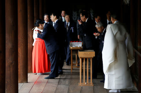 A group of lawmakers including Japan's ruling Liberal Democratic Party (LDP) lawmaker Hidehisa Otsuji (2nd R) sip sake as a ritual after offering prayers at the Yasukuni Shrine in Tokyo, Japan April 21, 2017. REUTERS/Toru Hanai