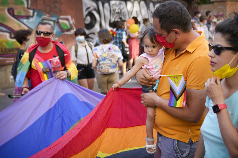 A child holds on to a large rainbow flag during the Bucharest Pride 2021 in Bucharest, Romania, Saturday, Aug. 14, 2021. The 20th anniversary of the abolishment of Article 200, which authorized prison sentences of up to five years for same-sex relations, was one cause for celebration during the gay pride parade and festival held in Romania's capital this month. People danced, waved rainbow flags and watched performances at Bucharest Pride 2021, an event that would have been unimaginable a generation earlier. (AP Photo/Vadim Ghirda)