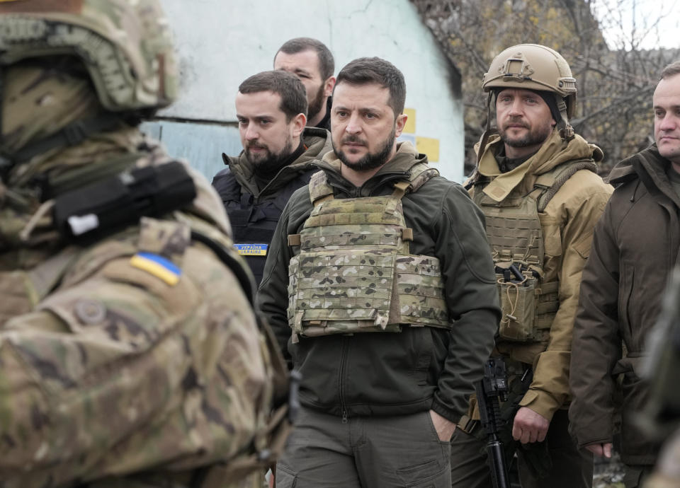 Ukrainian President Volodymyr Zelenskyy examines the site of a recent battle in Bucha, close to Kyiv, Ukraine, Monday, Apr. 4, 2022. Russia is facing a fresh wave of condemnation after evidence emerged of what appeared to be deliberate killings of civilians in Ukraine. (AP Photo/Efrem Lukatsky)