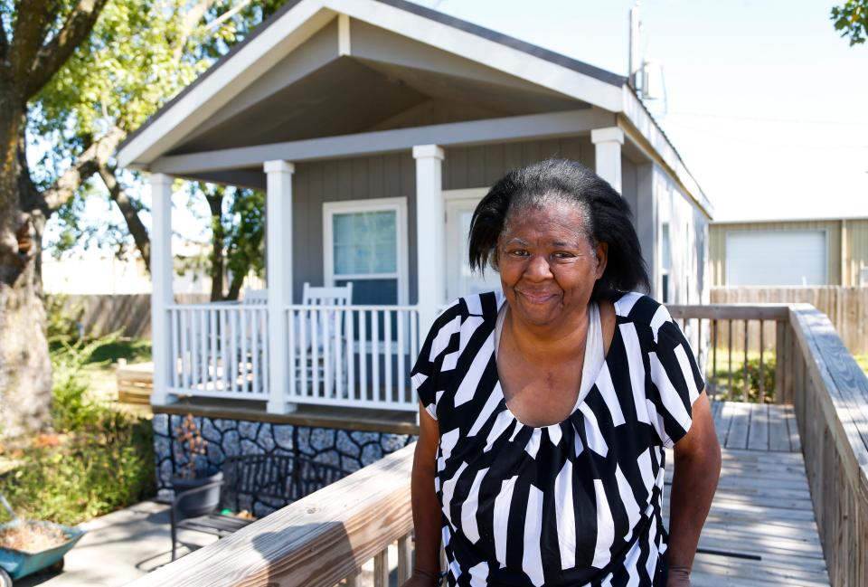 Teresa Ross on the front porch of her house at Eden Village on Monday, Sept. 26, 2022. Ross was one of the first residents to move into a home at Eden Village I on East Division Street nearly four years ago when it opened.