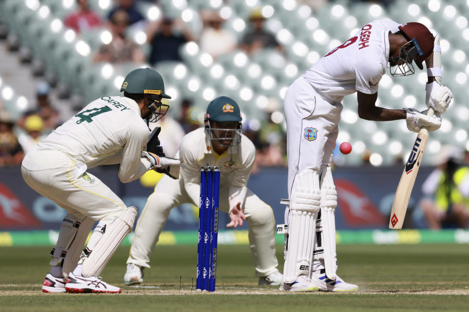 The West Indies' Alzarri Joseph, right, is trapped LBW by Australia's Nathan Lyon on the third day of their cricket test match in Adelaide, Saturday, Nov. 10, 2022. (AP Photo/James Elsby)