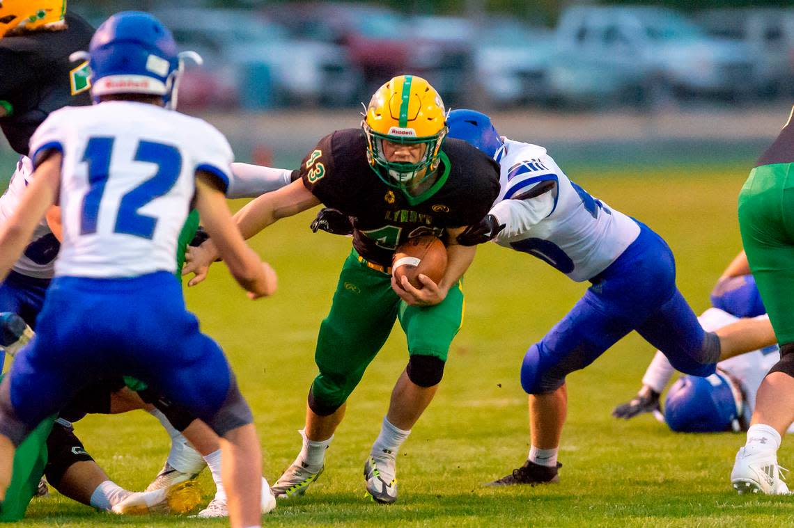 Lynden running back Lane Heeringa (43) moves through the line of scrimmage for a short gain during the first quarter on Friday evening Sept. 23, 2022, at Lynden High School in Lynden, Wash. Lynden continued their undefeated season winning 24 to 21 over Sedro-Woolley with a last minute touchdown.