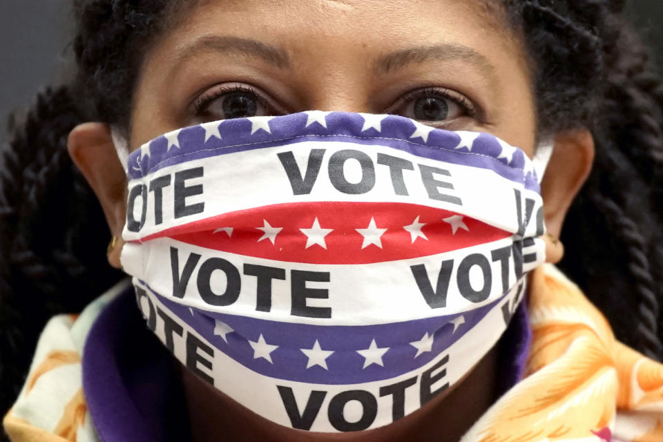 Maria Acosta wears a mask with a message as she attends the Women's March in downtown Chicago, Saturday, Oct. 17, 2020. (AP Photo/Nam Y. Huh, File)