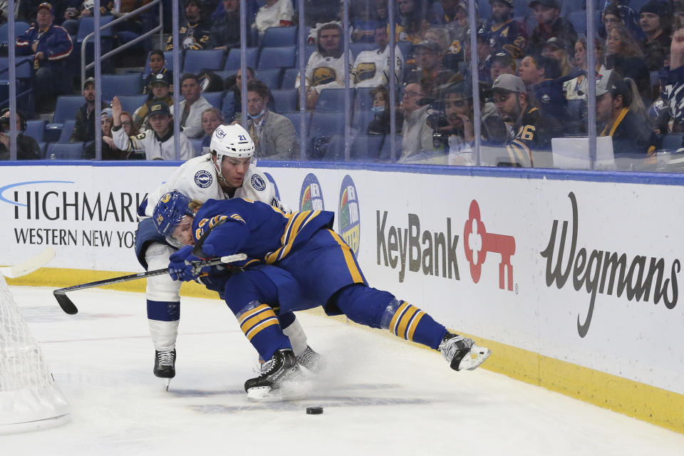 Buffalo Sabres defenseman Rasmus Dahlin (26) collides with Tampa Bay Lightning center Brayden Point (21) while going after the puck during the second period of an NHL hockey game Monday, Oct. 25, 2021, in Buffalo, N.Y. (AP Photo/Joshua Bessex)