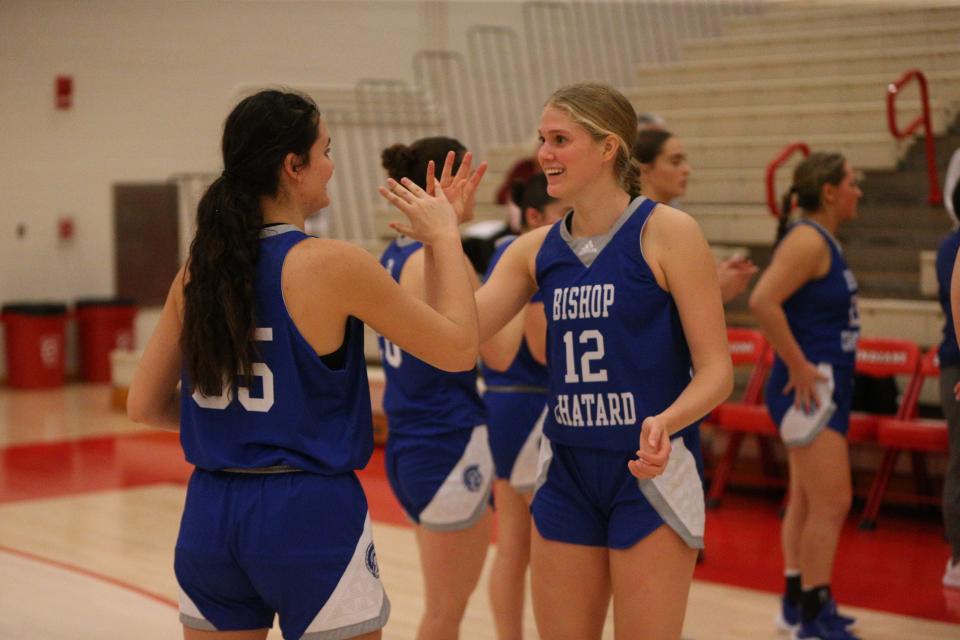 Bishop Chatard sophomore Olivia Berzai (right) is greeted by sophomore Betsy Tragesser (left) before playing Twin Lakes in the Twin Lakes Holiday Tournament semifinal on Thursday, Dec. 28, 2023.