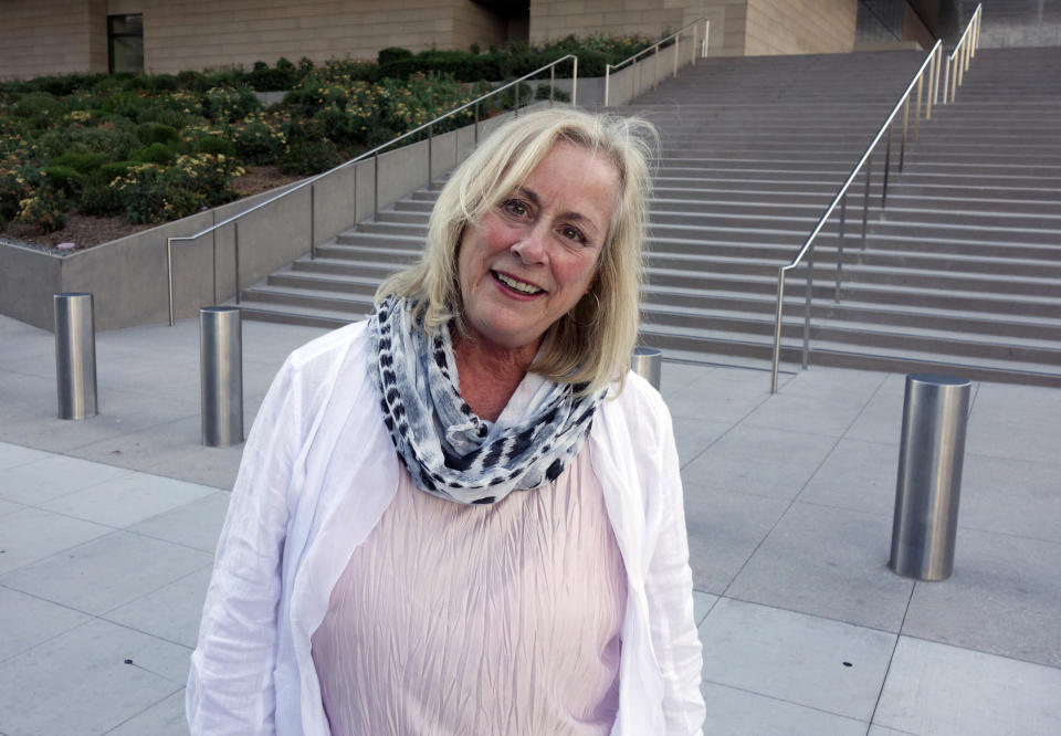 FILE - In this Aug. 29, 2017, file photo, Gail Steinbeck, widow of Thomas Steinbeck, the son of author John Steinbeck, leaves federal court in downtown Los Angeles. A federal appeals court has thrown out $8 million in punitive damages against the daughter-in-law of author John Steinbeck in her long-running copyright spat with the late author's step-daughter. The 9th U.S. Circuit Court of Appeals on Monday, Sept. 9, 2019, upheld a $5 million verdict against Gail Steinbeck and told her it's time to end her legal saga. (AP Photo/Brian Melley, File)