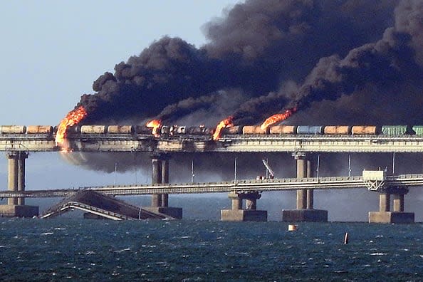 Black smoke billows from a fire on the Kerch bridge that links Crimea to Russia, after a truck exploded, near Kerch, on October 8, 2022. - Moscow announced on October 8, 2022 that a truck exploded igniting a huge fire and damaging the key Kerch bridge -- built as Russia's sole land link with annexed Crimea -- and vowed to find the perpetrators, without immediately blaming Ukraine. (Photo by AFP) (Photo by -/AFP via Getty Images)