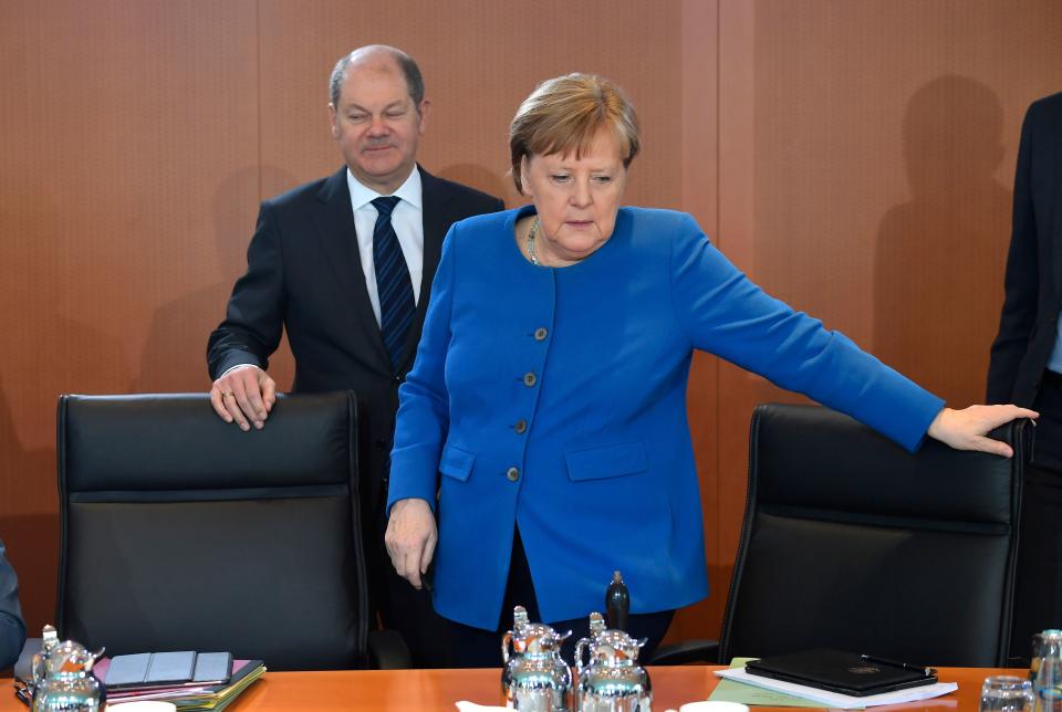 German Chancellor Angela Merkel and German Finance Minister and Vice-Chancellor Olaf Scholz arrive for the weekly cabinet meeting on March 11, 2020 at the Chancellery in Berlin. (Photo by Tobias SCHWARZ / AFP) (Photo by TOBIAS SCHWARZ/AFP via Getty Images)