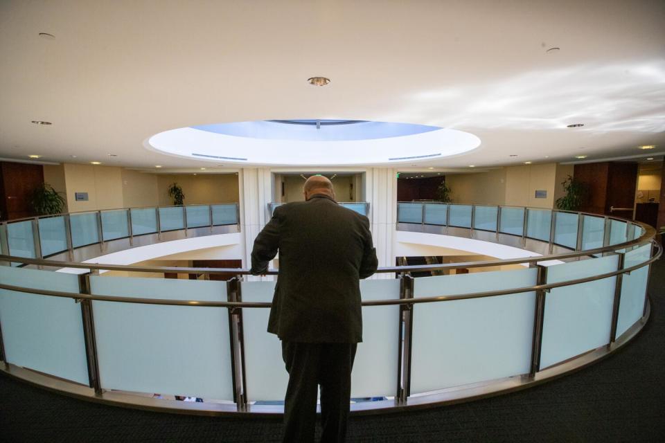 Hagekhalil seen from behind looking out at a circular rotunda inside a building.