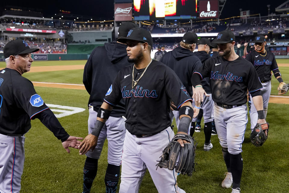 Miami Marlins third base coach Jody Reed, left, celebrates with Luis Arraez, front center, and others after a baseball game against the Washington Nationals at Nationals Park, Friday, June 16, 2023, in Washington. The Marlins won 6-5. (AP Photo/Alex Brandon)