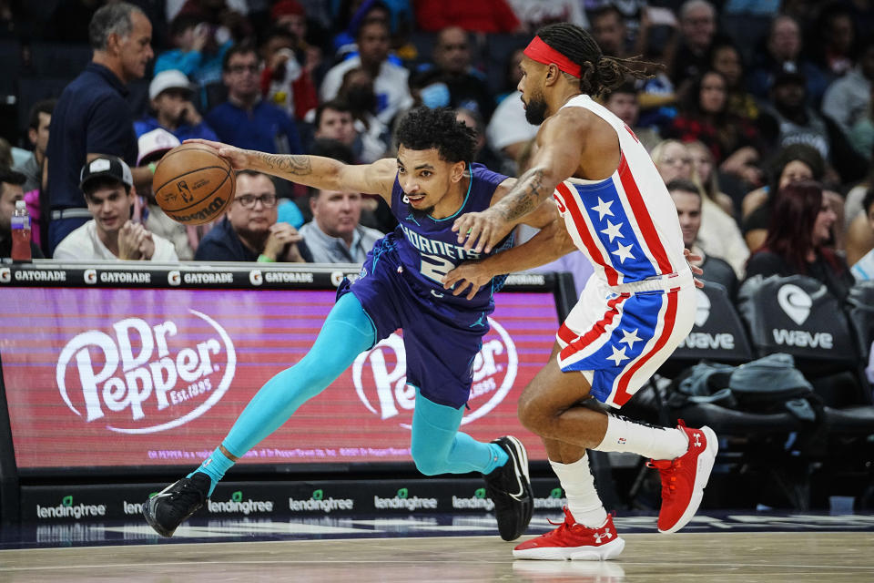 Charlotte Hornets guard James Bouknight, left, drives past Brooklyn Nets guard Patty Mills during the first half of an NBA basketball game, Saturday, Nov. 5, 2022, in Charlotte, N.C. (AP Photo/Rusty Jones)