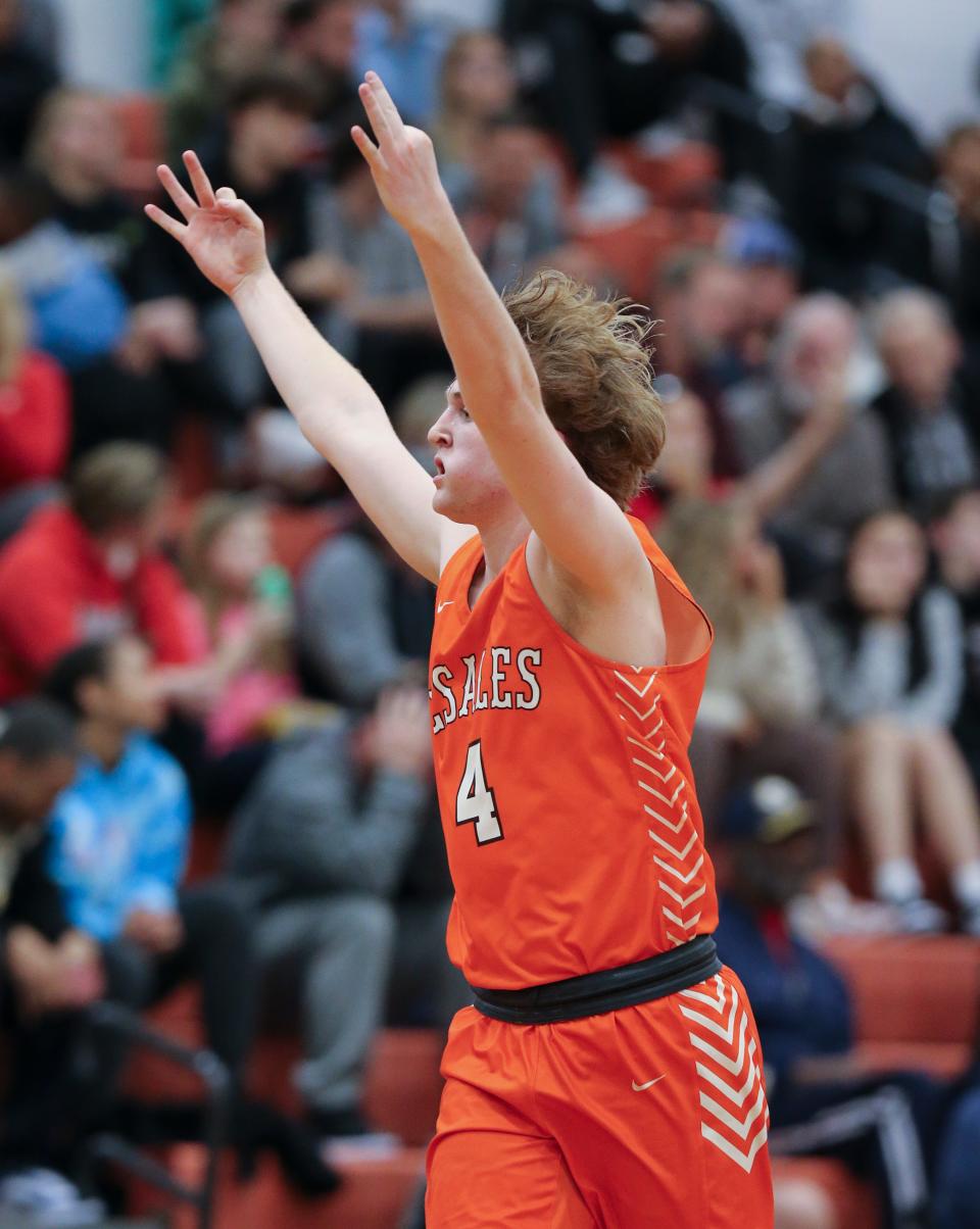 Desales' Tyler Klein (4) signals the three-point basket after he hit one against PRP during the Boys 6th Region quarterfinals at the PRP High School in Louisville, Ky. on Feb. 28, 2023.