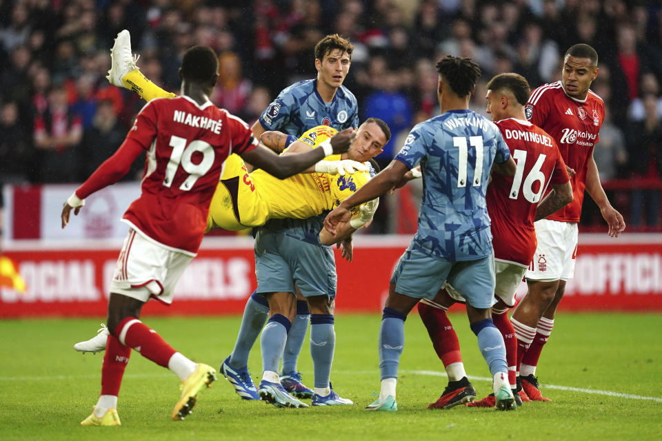 Nottingham Forest goalkeeper Odisseas Vlachodimos makes a save from pressure by Aston Villa players during the English Premier League soccer match between Nottingham Forest and Aston Villa at City Ground, Nottingham, England, Sunday, Nov. 5, 2023. (Nick Potts/PA via AP)