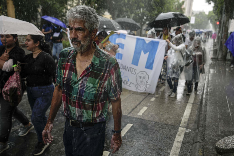 Demonstrators march in a downpour to support the electoral process in Guatemala City, Saturday, July 8, 2023. Chief Justice Silvia Valdes Quezada issued an order blocking the certification of the results for the first-round presidential June 25th election, late Friday. (AP Photo/Moises Castillo)