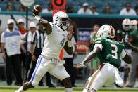 Central Connecticut State quarterback Romelo Williams (4) passes as Miami safety Gilbert Frierson (3) defends during the first half of an NCAA college football game, Saturday, Sept. 25, 2021, in Miami Gardens, Fla. (AP Photo/Lynne Sladky)