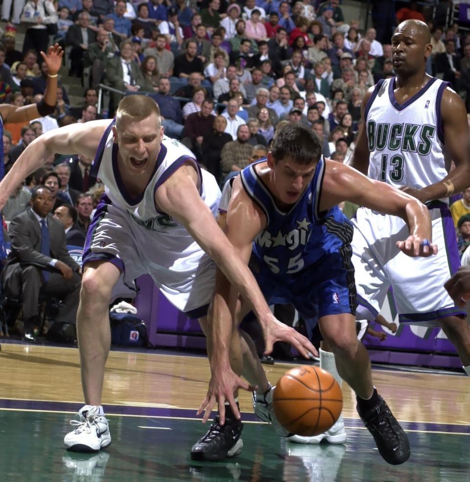 Mark Pope (left) and Andrew De Clercq of Orlando chase a loose ball during the first round of the 2001 NBA playoffs.