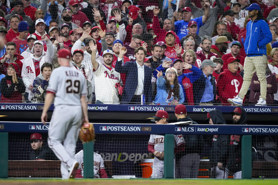Fans yell as Arizona Diamondbacks starting pitcher Merrill Kelly leaves the game against the Philadelphia Phillies during the sixth inning in Game 2 of the baseball NL Championship Series in Philadelphia, Tuesday, Oct. 17, 2023. (AP Photo/Matt Slocum)