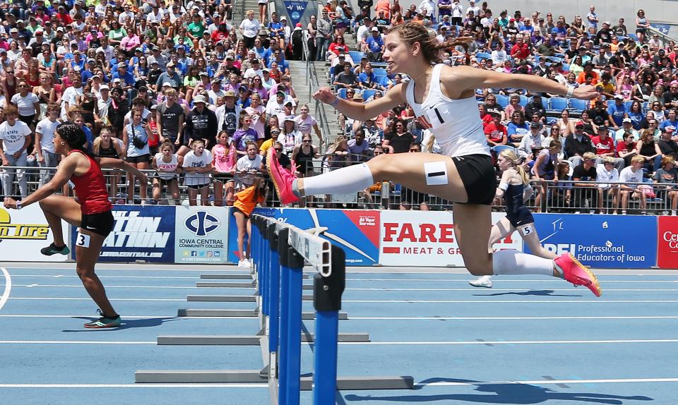 Solon's anchor runner Sophia Stahle crosses the hurdle during the 3A girls 100-meter shuttle hurdle relay in the final day of the Iowa high school state track meet.