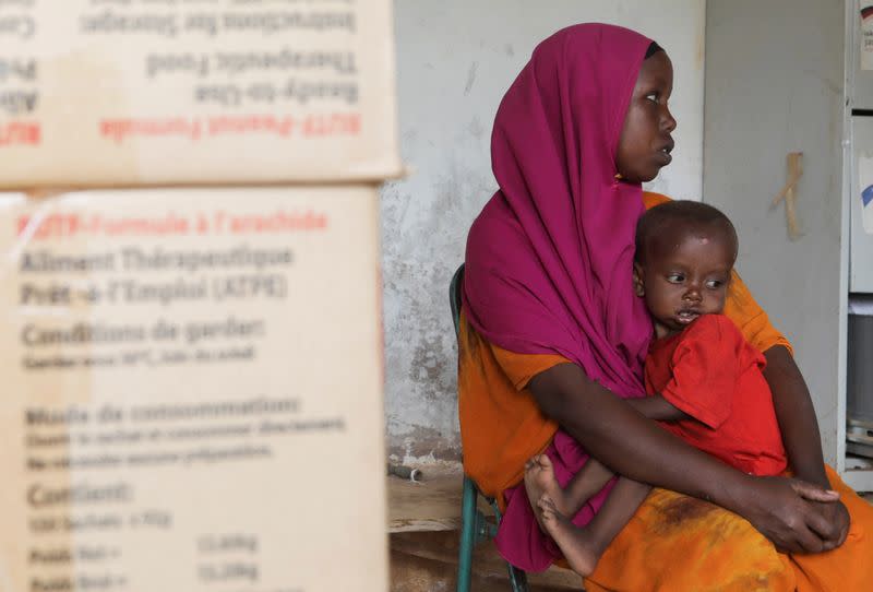Habiba Mohamed Noor, a Somali displaced woman holds her one year old malnourished child Hassan Mukhtar Mohamed after they arrived at the Dollow hospital in Dollow