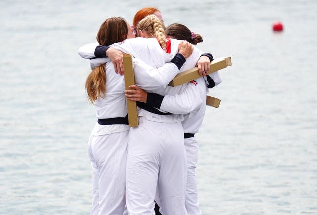 Lauren Henry, Hannah Scott, Lola Anderson and Georgie Brayshaw have a group hug after receiving their medals 