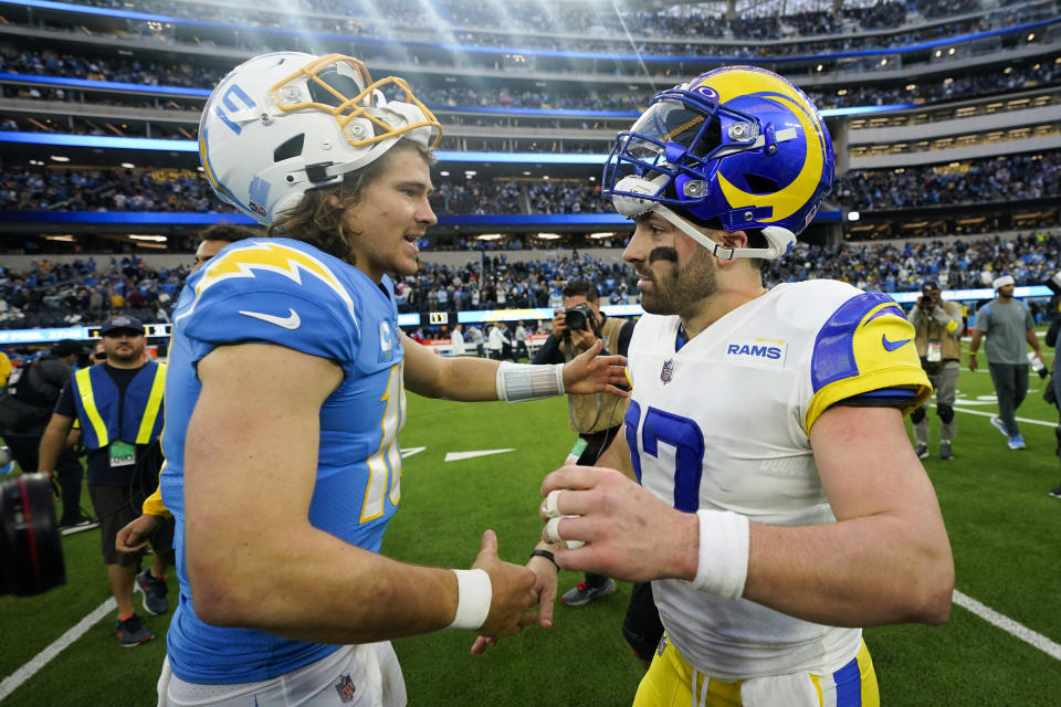 Los Angeles Chargers quarterback Justin Herbert (10) and Los Angeles Rams quarterback Baker Mayfield (17) shake hands after an NFL football game Sunday, Jan. 1, 2023, in Inglewood, Calif. The Chargers won 31-10. (AP Photo/Marcio Jose Sanchez)