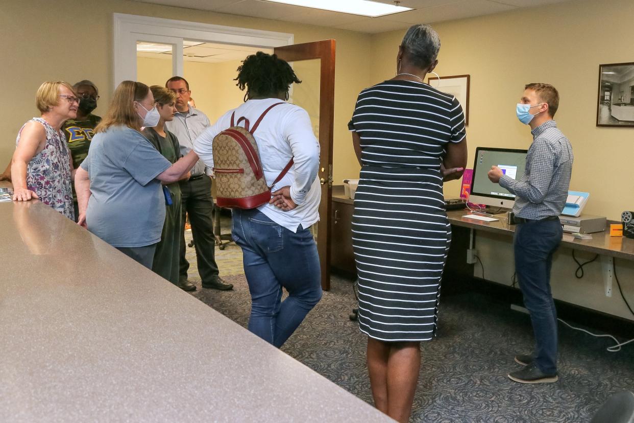 Joshua Bryant, a technology librarian, explains the capabilities of the Memory Lab to members June 8 during an open house at the Bexley Public Library. The lab allows users to convert analog media files such as photos, vinyl albums, VHS tapes and cassettes as well as 8mm movie film into digital formats.