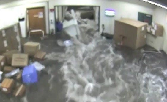 Water rushes into Norwood Hospital during major flooding June 28, 2020.